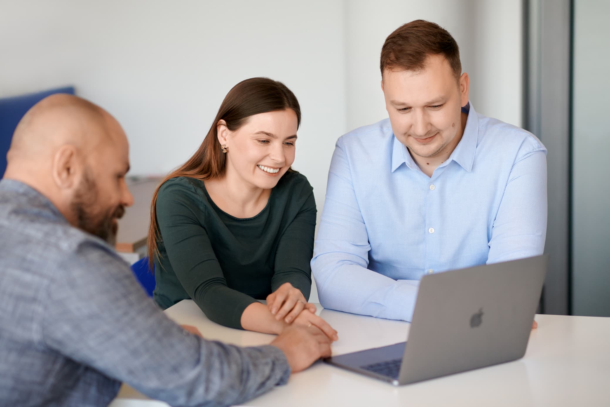 Woodwork for Inventor team photo at a laptop, smiling